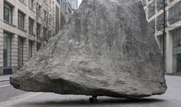 a rock balanced on a roller skate 