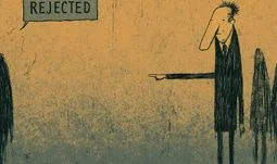 A man pointing and a sign that says rejected