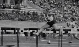 woman jumping a hurdle 
