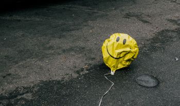 A balloon on the floor, looking a bit rough.
