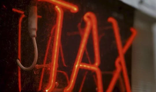 tax written in red lights 