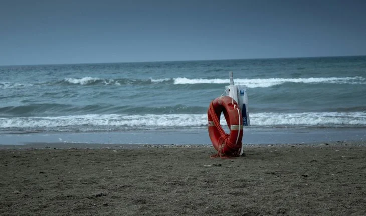 A lifebuoy on the beach.