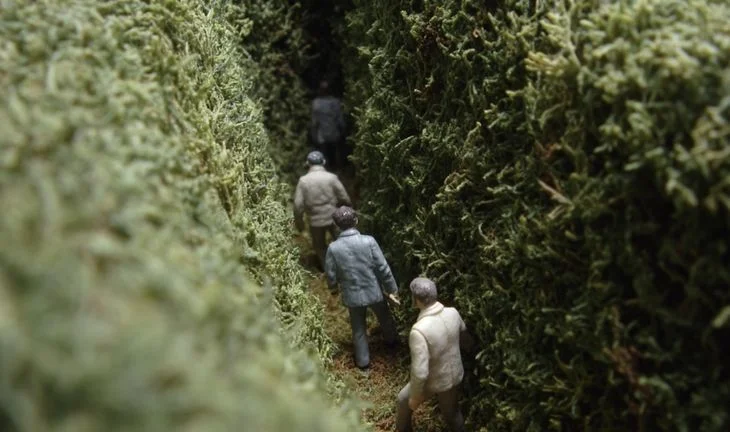 small men in a hedge 