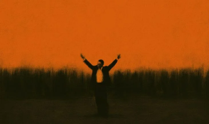 a small man with his arms in the air against an orange background 